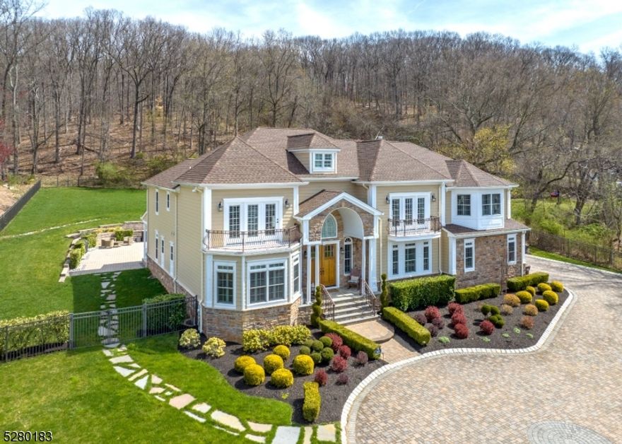 Built to the highest standards, carefully curated w timeless architecture & masterful construction at conception. Double-height entryway sets the tone inviting guests into a space that is impressive & welcoming. The potential for 2 in-law suites speaks to the versatility of the layout, catering to a variety of living arrangements. The kitchen equipped w Viking appliances, quartz surfaces will delight a chef while the adjacent breakfast nook offers a cozy spot for casual dining. The formal dining rm provides an elegant setting for entertaining. The main level also features practical spaces; a home office/library, bedroom en suite, powder & mudrm ensuring both style & functionality throughout. Upstairs the primary wing offers a serene retreat w walk-in closets, luxurious bath, dual fireplace & sitting rm + 3 additional generously sized bedrms. The walkout lower level is a haven for relaxation & recreation, boasting recreational areas, a gym, game rm, office, bedroom, full bath and kitchen for added convenience. The tiered property w its stone walls, irrigation system, gated property & ample outdoor entertaining space creates a picturesque setting for enjoying the surrounding natural beauty. Located in the coveted section of Martinsville, the allure is further enhanced by proximity to Warren/Basking Ridge residents can enjoy the convenience of chic boutiques & swanky restaurants while still experiencing a sense of tranquility & privacy