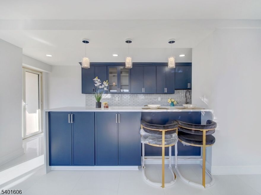 This gorgeous totally redone COOP is unlike any you have seen at Harrison Park Towers! This 8th-floor residence offers the same spacious layout and high-end renovation as the building's most in demand units. The custom blue kitchen cabinetry pairs with premium appliances and an open-concept galley design, including a built-in seating area for casual dining and entertaining. Features include three well-proportioned bedrooms, two newly renovated modern baths, and marble flooring throughout, delivering a polished and cohesive aesthetic.Amazing south and west views will make it hard to look away. Building amenities include 24-hour concierge, all utilities included, underground parking ($60/month; one space available), NYC jitney, private garden, gym, and laundry. Convenient access to GSP and Route 280.Owner occupancy only. Co-op board approval requires at least. 20% down payment required. Ownership 433 shares   $2,087 monthly maintenance (includes taxes and all utilities - heat, hot water, sewer, water and electric). Square footage approximate. Come fall in love.