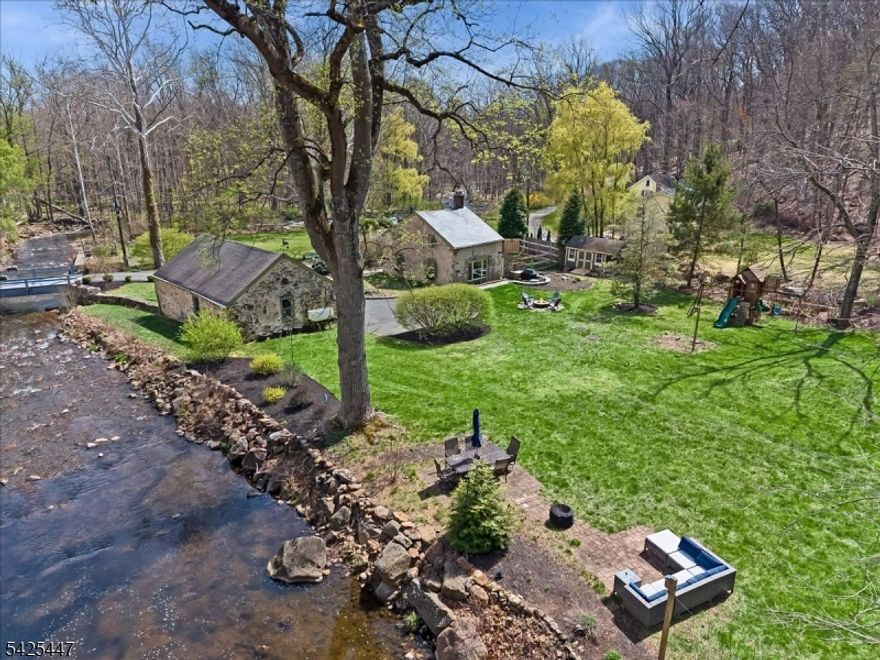 Step back in time at this historic stone home nestled along the beautiful South Branch of the Raritan River in Mount Olive Township. Tucked away on private Mill Road, this rare property offers a remarkable blend of history, serenity, and breathtaking natural surroundings, while still providing exceptional convenience.The charming home features 2 bedrooms and 1 full bath, filled with warmth and character that reflect its historic roots. From the moment you arrive, the setting feels peaceful and timeless, with the soothing sounds of the river and scenic natural views creating a truly special atmosphere.A second stone building adds incredible versatility. One side offers a garage with a large storage loft, while the other provides a finished bonus room ideal as a guest cottage, home office, studio, or creative retreat.The backyard is simply magical, highlighted by a stunning stone wall dating back hundreds of years, adding to the property's storybook charm. Set directly along the South Branch of the Raritan River, a renowned Grade A trout stream, this is an exceptional setting for nature lovers, anglers, and anyone seeking a peaceful escape.Despite its tranquil setting, the property is also a fantastic commuter location. Routes 46, 80, and 206 are just minutes away, easy access to NYC. Shopping, restaurants, and everyday conveniences are nearby, yet when you are home, it feels worlds away. A rare opportunity to own a piece of history in an extraordinary setting.