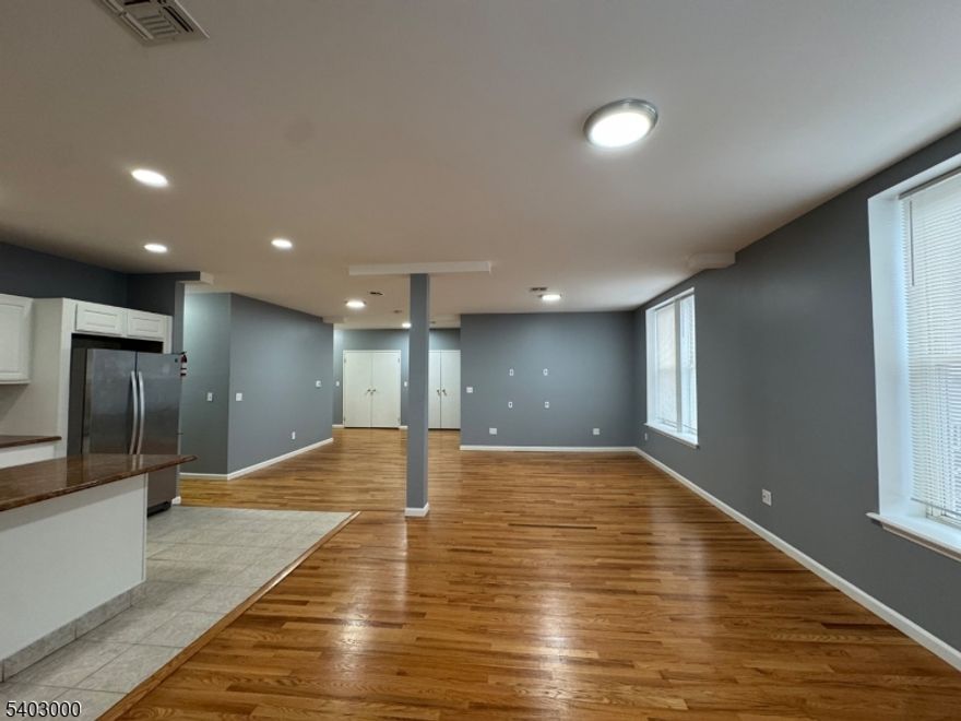 Discover this stunning 2,100 SqFt, third-floor apartment in the heart of Kearny, New Jersey! This bright and spacious apartment features four bedrooms, including a large master suite, and two full bathrooms, making it perfect for anyone that loves extra space.  The open-concept layout seamlessly connects the kitchen, dining, and living areas, creating a modern and welcoming environment. The kitchen is a chef's dream, equipped with stainless steel appliances, an island with additional seating, granite countertops, and ample cabinet space for all your storage needs. The combined dining and living room area is expansive, offering the perfect space for entertaining and relaxing.  This home boasts beautiful hardwood floors, recessed lighting, central air and forced heat, ensuring comfort year-round. Storage is abundant with plenty of closet space, and the numerous windows fill the apartment with natural light throughout the day. Additional conveniences include a brand-new in-unit washer and dryer and an intercom system for secure front-door communication.  Situated in a prime location just blocks from Kearny Avenue, this apartment is close to shopping, dining, schools, parks, and houses of worship. Public transportation is a breeze, with bus stops right at the corner, major highways nearby, and the Harrison PATH Train Station only 2.6 miles away. This is truly a commuter's dream!  Don't miss the opportunity to make this exceptional apartment your new home!