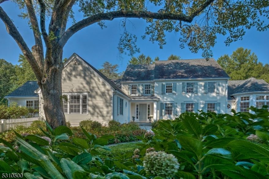 A stone wall entry leads up a beautiful tree lined drive to this storybook colonial. The circular drive is the perfect entry to this gracious custom home w/ open and spacious floor plan that is perfect for entertaining both inside & out. Attention to detail has been paid to every inch of the home including the cove lit, tray ceiling of the dining room, beam & beadboard detailed family room that opens to the soaring height of the light filled kitchen. A bay window with banquet seating overlooks the front garden and the large kitchen island offers wonderful storage and workspace. A covered porch sits off of the rear of the house with bluestone patios, mature gardens with views of the large & open property. The primary bedroom sits conveniently on the first floor. A private entry opens to this lovely suite with a beautiful marble detailed bath, w/ soaking tub & steam shower, two generous walk in closets, stackable washer/dryer and a bedroom area w/ large picture window, adjacent to a sitting room with french doors to a private patio space overlooking the private side yard. The second level has two bedrooms with a large shared bath, built ins & picture windows overlooking the property. The side door leads to the mudroom, laundry room, oversized 3 car garage & a large and bright bonus room. A gym and storage space on the lower level completes this well designed and wonderful home. Set off of one of Harding's favorite roads with easy access to Morristown and Chatham.