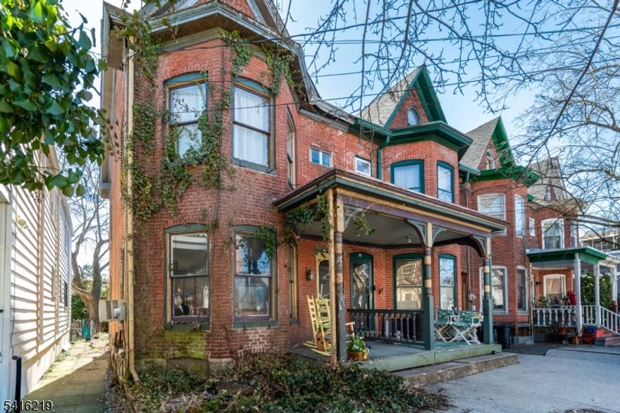 Lambertville's streets are defined by rows of historic brick houses and architectural details that have endured for generations. This home carries the hallmarks of the town's historic fabric, with original materials and a floor plan that unfolds with surprising scale. A covered front porch introduces the house before stepping inside to pumpkin pine floors & richly textured exposed brick walls accented with picture-frame wood trim. The living and dining rms sit side by side, creating a long, continuous gathering space. A bay window pushes the footprint outward, bringing in light and adding dimension. In the living room, a gas fireplace is framed by a wall of built-ins, creating a focal point that adds even more architectural character. The kitchen is dine-in and generously sized, with plenty of room to reimagine the space. A 1st fl full bath & laundry add everyday. A Dutch door opens to the backyard, a space ready for transformation, whether envisioned as a layered garden, patio, or outdoor dining area surrounded by plantings.The 2nd fl has 3 bedrooms, including the main with another bay window and a second full bath, while the third floor houses a large fourth bedroom beneath the roofline. From here, Lambertville's galleries, caf s, and riverfront paths are just a short stroll away. Life in town moves easily between historic streets, the Delaware River, and a vibrant arts and dining scene, an enduring setting for a home with both history and possibility.