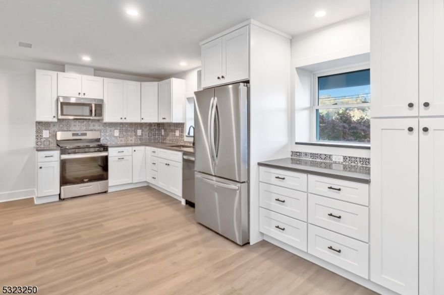 Welcome to this COMPLETELY RENOVATED Duplex unit featuring 3 spacious bedrooms and 2.5 stylish bathrooms. The unit offers a modern kitchen with ample cabinetry and new appliances, perfect for cooking and entertaining, laminate flooring, and recessed lighting. There's an additional room ideal for a home office or guest space, family room and a dining area. 3 assigned parking spots and access to a nice wrap around deck. Located within walking distance to vibrant Downtown Morristown, you'll have easy access to a variety of restaurants, shops, entertainment options, and the NJ Transit direct train to NYC. Plus, it's just minutes from major highways for effortless commuting. Don't miss this opportunity to live in one of Morristown's most sought-after areas!