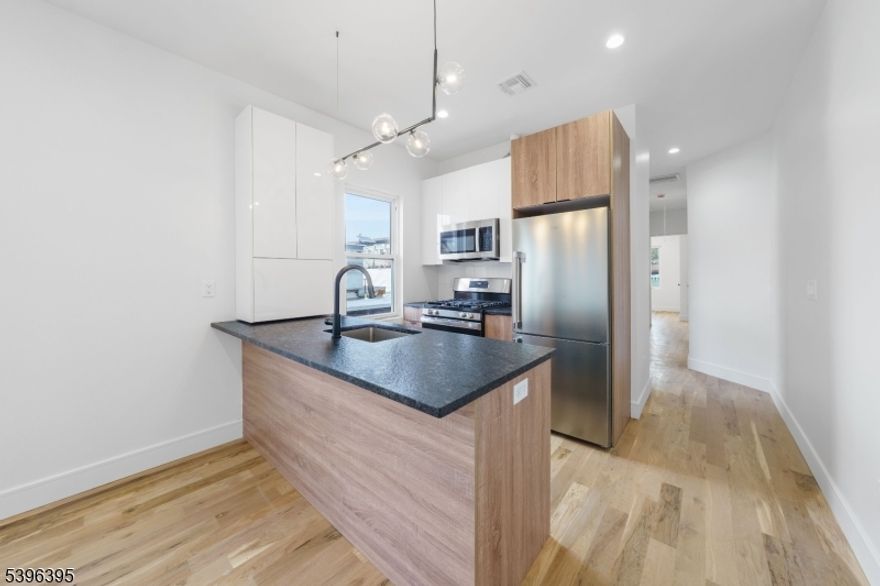 Welcome to 114 Center Street in the heart of Garwood. A completely renovated two-bedroom apartment blending designer style with everyday convenience.  The open- concept kitchen and living room create a bright, modern space perfect for entertaining or relaxing. Enjoy a brand-new kitchen with stainless steel appliances, sleek cabinetry and quartz countertops, as well as newly designed bathrooms. The apartment also features a video camera intercom security system with buzzer entry. Enjoy small-town charm with urban convenience.  You're close to the Garwood Train Station for easy NYC commuting, and near top-rated local Pre-K and elementary schools. You'll also love the proximity to the neighborhood favorites - gyms, cafes, shops, Kings and ShopRite of Garwood, restaurants, and parks all within minutes. Complimentary parking pass included for first year lease term. The first month's rent will be covered by the landlord.