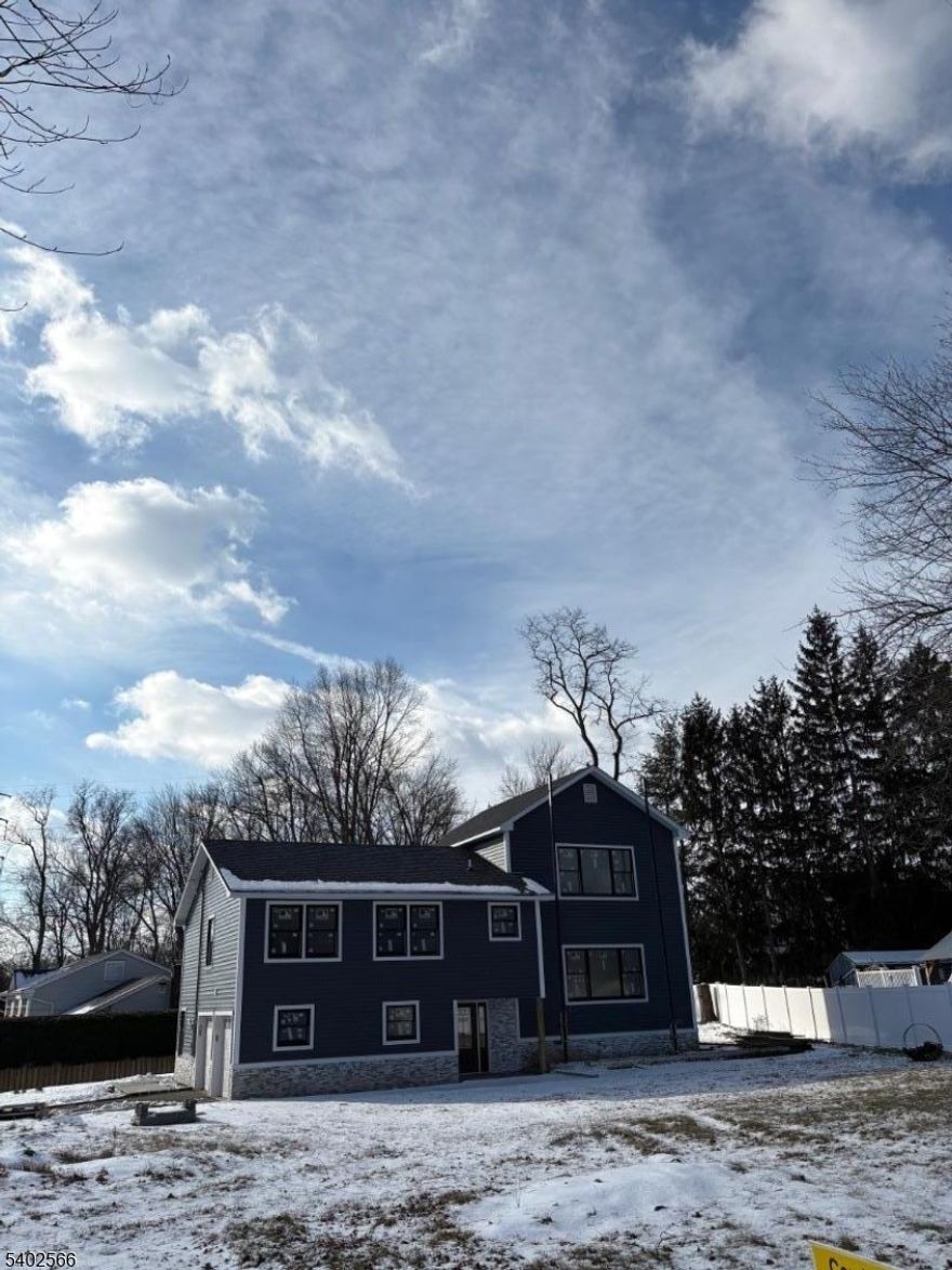 Totally renovated in 2025!!  A New Home for the New Year!  Luxury abounds in this magnificent, one-of-a-kind, custom style home offering 4 bedrooms and 3.5 bathrooms. The home offers hardwood floors throughout and a thoughtfully designed open-concept layout-perfect for today's lifestyle. The stunning kitchen is the heart of the home, complete with quartz countertops, abundant cabinetry, high-end appliances, and a breakfast bar -effortlessly flowing into the dining and living areas-ideal for everyday living and entertaining. A spacious deck is situated outside the dining area-perfect for hosting guests or enjoying a quiet morning coffee or evening cocktail. All bedrooms are generously sized. The private primary suite, set apart for added privacy, offers a true retreat with a spa-inspired bathroom featuring a tub/shower plus a large walk-in shower. In addition to the primary suite, there is also a guest suite with full bathroom.  The family room opens to a paver patio overlooking a serene, park-like yard. A finished basement provides additional living space, while a 2 car garage adds everyday convenience. Nestled in one of East Hanover's premier neighborhoods, along with top-rated schools, this home delivers an exceptional sense of peace and friendly community living. Ideally located near major highways, NYC trans, shopping and dining-convenience is at your doorstep. Brand new construction with top of the line finishes and a sleek modern design, this home truly has it all.