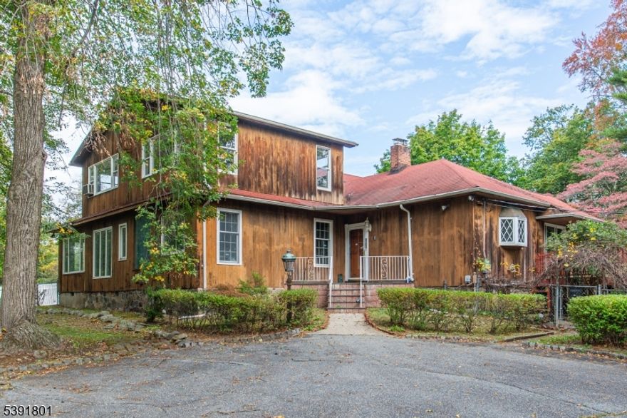 Own a piece of Heaven with the estate like property set on 2.7 acres in the Heart of Parsippany.   Almost 4000 (3995 per tax record) sq ft, this recessed away from the street, home is unlike any other home on the market today.  This home has character, detached 3 car garage, 2 tiered deck, and park like property.   The value is in the land with 2.7 acres and away from the Rockaway River and away from the street - set up on a mountain.   Front entry way with dry bar and living room with wood burning fireplace, large room sizes, leading to a enormous family room w/sliders to yard. Updated kitchen with new appliances, wood cabinets with corian countertops, center island breakfast bar leading to a sizable dining room with wood burning fireplace, exposed beams on vaulted ceiling, and sliders to 2 tiered deck..   Additionally on this floor are a sun room (with w/d connection) and a den/office.   Upstairs is 3 additional bedrooms with full bath.    Basement is used for storage, w/d, and utility room.   Options are endless, update the current home with a clean slate to make your own, expand on the current structure, knockdown the current home and build a new home, or maybe subdivide the land if possible (buyer must do their due diligence).  Home has public utilities including public water/sewer, natural gas.  Home is in Parsippany with a Boonton mailing address.  Close to NYC Park and Ride Bus and nearby train stations.  Close to major arteries such as Rts 46, 80, 287, 10, and 280.