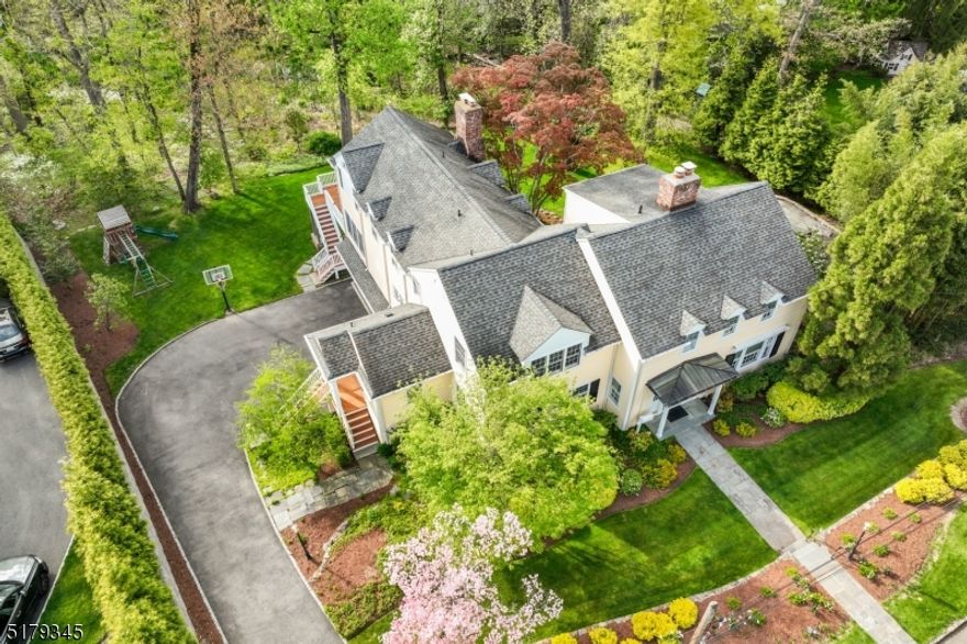 Spectacular Short Hills residence on expansive 1.6 acres lot. Sensationally renovated & expanded custom home situated in prestigious Beechcroft section provides exquisite designer finishes throughout & multiple outdoor entertaining spaces with plenty of options for a pool.  Located in the sought-after Deerfield Elementary School district, this luxurious home provides a fabulous Living Room that transitions via French doors to breathtaking Sunroom boasting Travertine marble floors, a dramatic vaulted ceiling window, radiant heating & access to the recently upgraded patio w/ new retaining Fieldstone wall & built-in Lynx BBQ w/ a gas line. Recent renovations include a new sleek white Chef's Kitchen (2020) w/ high-end stainless steel appliances (Viking and SubZero), quartz countertops, enormous center island plus eat-in area. Kitchen opens to fabulous Family Room & oversized Deck overlooking the lush, idyllic rear grounds. Formal Dining Room provides privacy doors to both Foyer & Kitchen. 1st floor Home Office converts to 7th bedroom. 1st floor Laundry & Powder Room. Primary Bedroom Wing features a sumptuous NEW (2020) Primary Bath w/ energy-efficient radiant heat, dual vanities w/ quartz countertops, jetted soaking tub & glass-enclosed shower.  Across the hall is a Junior Suite. Beyond the Primary Wing, 2 Bedrooms share an updated Full Bath (2022).  Two additional Bedrooms on top level enjoy oversized closets & share a fully renovated (2022) Hall Bath. You don't want to miss it!