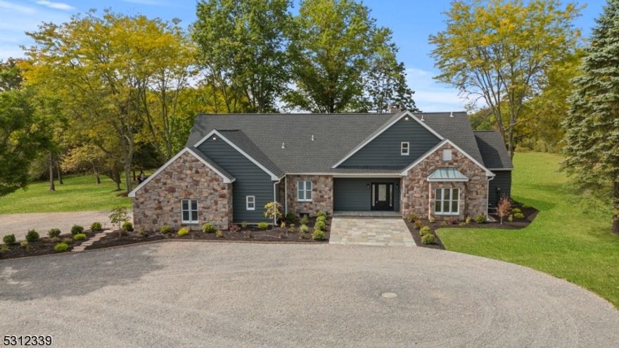 **Stunning lakefront retreat with panoramic views!** Anticipation builds as you follow the long private drive meandering across a rolling landscape leading to this special residence overlooking 51 acres and a glimmering Lake. Whether lounging on the expansive blue stone patio or enjoying the well appointed interior, this custom home offers breathtaking views at every turn with Amwell lake always in sight. From the moment you enter the gracious foyer, expansive windows provide a picturesque backdrop of nature and water views. The living space is adorned with high ceilings, warm hardwoods and a beautiful stone fireplace. The new gourmet kitchen boasts high-end Thermador appliances, custom cabinetry and a spacious island. A luxurious primary suite, located on the main level, is a private sanctuary with inspiring views, a walk-in closet, and a spa-like ensuite featuring a glass enclosed shower and custom tile work. Imagine waking to serene water views from the comfort of your bed. Plus, the first floor office could easily serve as an additional bedroom or den. But of course, there is more. The open staircase leads to a wide overlook on the upper level serving 3 additional spacious bedrooms and another custom bathroom. Still, the massive unfinished basement with high ceilings provides more potential . Live in tune with the outdoors as this fine home sits high on just over 51 gorgeous acres. Perfect for enjoying wildlife, sunset kayaking, and a variety of recreational activities .