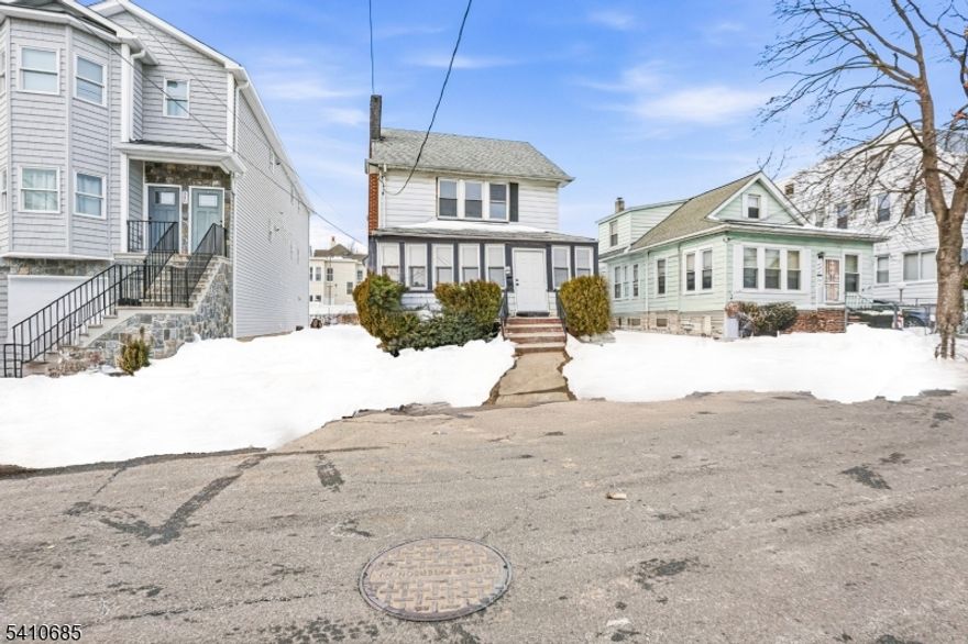 Welcome to 338 E 19th St, a beautifully renovated Colonial offering modern upgrades, comfortable living space, and a functional layout in Paterson. This inviting home features three spacious bedrooms and two full bathrooms, beginning with a bright living room highlighted by a classic fireplace, a formal dining room perfect for gatherings, and a stylish kitchen complete with a breakfast bar and separate dining area. Upstairs, you'll find three well-sized bedrooms and a full bath, while the unfinished basement provides additional storage potential. A private driveway adds convenience, and the thoughtful renovations throughout give the home a clean, move-in-ready feel. Conveniently located near shopping, parks, schools, and transportation, this home offers comfort, style, and value. Grab it before it's gone.