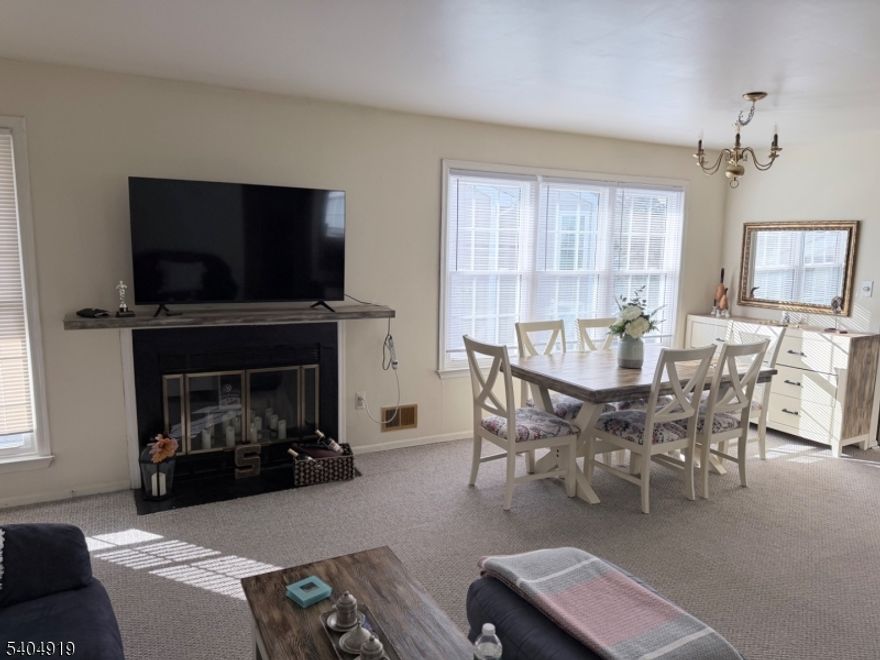 NYC bus service located directly in front of the condominium complex, offering outstanding commuter convenience. This 2-bedroom, 2-bath residence features a wood-burning fireplace, new windows, a new furnace, washer and dryer in the unit, and two separate entrances. The layout provides excellent privacy, with each bedroom offering direct access to a full bathroom, including a primary bedroom with a walk-in closet. A covered rear porch offers a comfortable outdoor space for seating and relaxation. Located within a gated community with access to a seasonal outdoor association pool. Ideally situated near Route 22 (north and south) with extensive shopping, dining, hospitals, and emergency services just minutes away. A well-positioned home combining comfort, privacy, and everyday convenience.