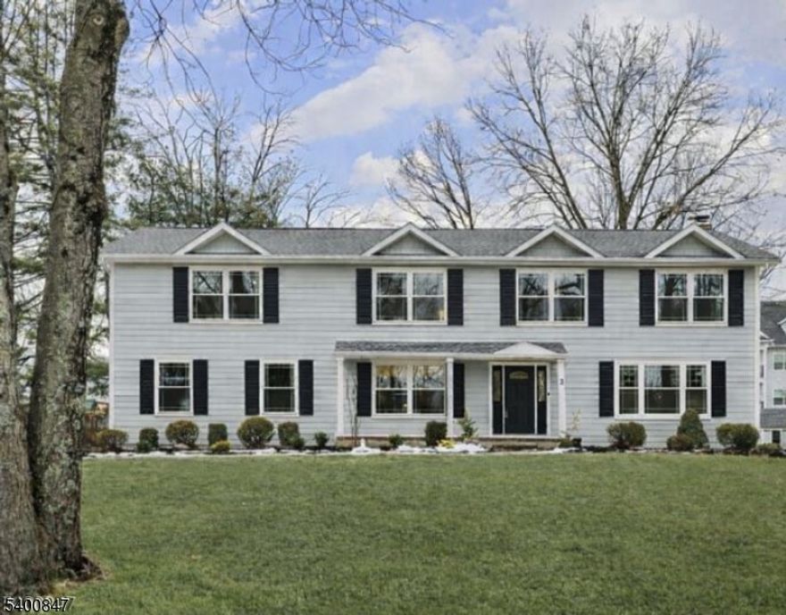 Discover exceptional design and superior craftsmanship in this stunning 5-bedroom, 3.1-bath home, where every detail has been thoughtfully curated to blend luxury, comfort, and modern functionality. An inviting open front porch welcomes you to a home wrapped in durable Hardie Plank siding and enhanced by professional landscaping, a front and a spacious deck ideal for outdoor entertaining and year-round enjoyment. Step inside to a bright, open floor plan showcasing refined finishes, timeless style, and custom closets throughout. The heart of the home is the chef-inspired kitchen, featuring premium Thermador stainless steel appliances, custom soft-close cabinetry, sleek quartz countertops, and a center island with seating. The adjacent dining area is perfect for gatherings, while the family room with a classic wood-burning fireplace creates a warm, inviting atmosphere. A living room, mudroom with built-ins, and powder room complete the first floor. Upstairs, the expansive primary suite offers a vaulted ceiling, walk-in closet, and spa-like bath with soaking tub, stall shower, and dual-sink vanity. Four additional spacious bedrooms, two full hall baths, and a generous laundry room complete the second level. The full, finished lower level provides  even more living space with a large recreation room and play area. Ideally located minutes from schools and parks, this home offers both convenience and unparalleled style.Taxes do not reflect renovation.