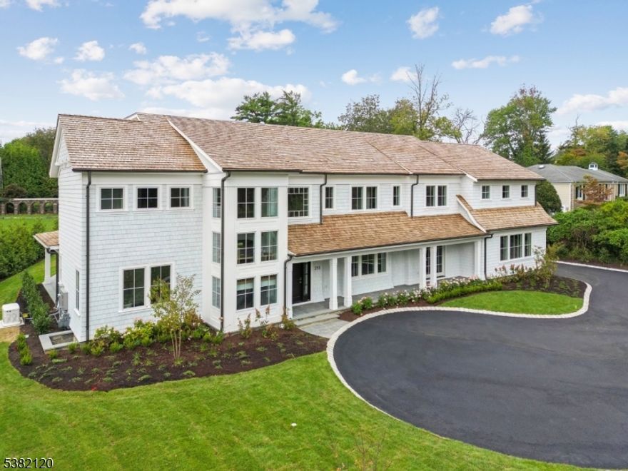 A custom-built masterpiece blending architectural intrigue with everyday luxury. Welcome to 293, crafted by Short Hills' premier Build-Design Group: Singer Properties. This home features soaring ceilings, a dramatic floating staircase, and wide-plank white oak flooring with herringbone inlays. The designer gourmet kitchen showcases quartzite countertops, custom cabinetry, a 48  Sub-Zero and Wolf appliances. The primary suite offers a celebrity-worthy closet, while additional spaces include a home gym, multiple entertaining areas, and a changing/powder room thoughtfully designed for a future pool. Outdoor living is elevated with a covered bluestone patio and a charming covered front porch. Set on a professionally landscaped, level property, the home also includes a 3-car on-grade garage, designer finishes throughout, a new home warranty and built-in generator - all with easy access to coveted Deerfield School, Old Short Hills Park, Taylor Park, Downtown Millburn, The Mall at Short Hills, and Midtown Express Trains.
