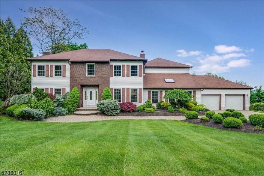 Hawthorne Heights' premier 5BD, 4BTH, center hall colonial, offers 4,490 sq ft of luxurious living space with breathtaking NYC skyline views and lush foliage on just under an acre. This mini estate, featuring a three-tier backyard, is less than 30 minutes from NYC via in town train station. The foyer offers two CLOS and the front stairwell. The spacious FLR boasts HW, WBFP, and recessed lighting, leading to FDR with main deck access. The updated, EIK includes a glass lit breakfront cabinet w/wet bar, soft-close cabinets, granite countertops, SS appliances, and 6 burner hooded stove.  The large sunken FR features cathedral ceilings, a skylight, HW, and a floor-to-ceiling stone WBFP.  Adjacent is a sunroom with NYC skyline views, a wet bar, ref, wine cooler, and access to two decks. This level also includes a full BTH and access to the two-car attached garage.  The 2nd level offers a primary suite with a sitting room, custom-built WIC closet, and an updated ensuite BTH with a Porcelanosa soaking tub, double vanity, and separate shower stall. Four additional BD, 2BTH, and a laundry room are also included.  The ground level has a flex space with a laundry area and w/o to the backyard. The unfinished bsmt offers potential for additional space.  The beautifully landscaped backyard provides endless possibilities. With beautiful curb appeal, 4+ car parking, and nearby to downtown, shops, restaurants, Goffle Brook Park, and major highways, this home is a perfect year-round retreat.