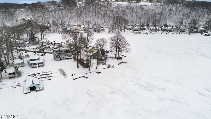 Welcome to lakefront living on Lake Hopatcong, New Jersey's largest lake! Set on an oversized .39-acre lot, originally two separate parcels, this unique property offers space and privacy rarely found in the neighborhood. A previous home was removed years ago, creating an expansive setting with endless potential. The gently sloping yard leads you right to the water's edge, where two private docks invite you to boat, swim, fish, or simply relax and take in the views. Inside, the home features a spacious living room with lake views from the peninsula, a generously sized dining room perfect for gatherings, a galley kitchen, cozy den, full bath, and two comfortable bedrooms. Public sewer and central air conditioning provide added convenience and comfort. Tucked away at the end of a quiet cul-de-sac, the property offers both privacy and direct access to the lake lifestyle you've been dreaming of. Enjoy nearby restaurants, shopping, and easy commuting via Route 80. If you've been searching for a large lakefront lot with incredible potential on Lake Hopatcong, this is the opportunity you've been waiting for!!