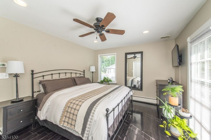 Welcome to this charming 3 bedroom, 2 bath ranch in a fantastic location, just a short walk to downtown Netcong. Offering a perfect blend of comfort and convenience, this home features an inviting open floor plan with vaulted ceilings, skylights, and gleaming laminate floors that fill the space with natural light. The updated kitchen is complete with all new stainless steel appliances and opens to a deck, ideal for entertaining or relaxing outdoors. The spacious primary bedroom includes its own private balcony, while recessed lighting and central air add modern touches throughout. The finished basement offers additional living space with a cozy wood-burning fireplace, creating the perfect spot for gatherings. Outside, enjoy a fenced-in backyard and large side yard with fire pit, plenty of parking, and a 1-car garage. With its desirable location and thoughtful updates, this home is move-in ready and full of charm.