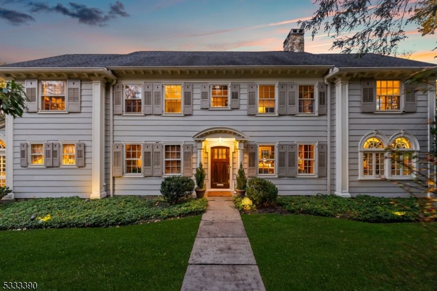 Welcome to Altamont, a unique residence atop First Mountain on Montclair's prestigious Lloyd Road, blending town and country living. This stately Palladian home offers breathtaking views of the Manhattan skyline, with sunrises and sunsets over Eagle Rock Reservation's 500 acres of trails. Built in 1919, it combines timeless craftsmanship with modern updates. Antique glass windows bathe the home in natural light, framing stunning views of Montclair and Manhattan. Generous rooms with soaring ceilings, elegant moldings, and 3 fireplaces create an inviting atmosphere. The custom kitchen features hand-cerused white oak cabinets, hidden storage, oak dovetail construction, and limestone quartz countertops. Expansive windows in the breakfast area offer uninterrupted views of Manhattan. The Sun Room w/Palladian windows is not to be missed. Upstairs, the primary suite w/gas fireplace, dual-facing windows, and sunroom/office. 5 additional bedrooms offer spectacular NYC skyline views. Fr doors open to an expansive deck cantilevered over gardens. The full-floor walkout garden level has 10-foot ceilings, flexible spaces, + panoramic skyline views. Modern amenities include steam heat, zoned central air, + integrated music system. Just minutes from Montclair's dining, boutiques, and cultural attractions, Altamont offers a private sanctuary with terraced gardens and mature landscaping, and convenient access to major highways, Newark Airport, and NYC.