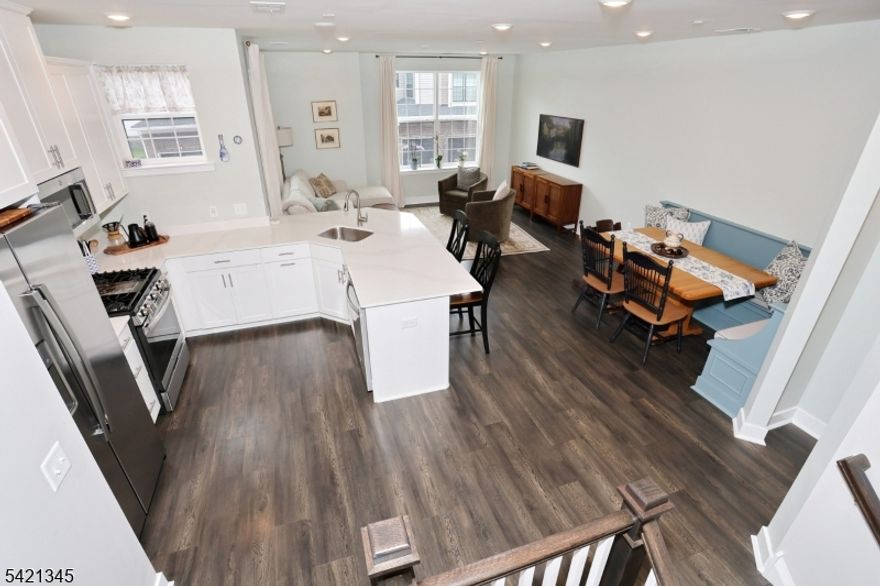 Welcome to The PARKE where carefree and maintenance free living begins.  This Hampton model offers 2042 square feet of living space featuring an open concept living and dining area, kitchen with stainless appliances and quartz countertops as well as a pantry and powder room on the main level.  The primary bedroom with ensuite, 2 additional bedrooms, another full bath, laundry and a great flex space are all located on the second level.  The custom built in seating in the dining area has extra storage and the custom blinds make this unit ready to move right in.  The spacious garage can accommodate a vehicle and storage and is equipped with an EV charging outlet.  Little Falls is centrally located near transportation to NYC, great restaurants, coffee shops and tons of shopping.  This beautifully maintained unit is a must see !