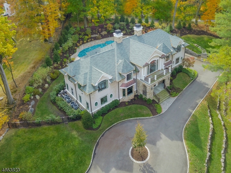 Resting on nearly an acre, this gorgeous 2 Story Grand Entrance Hall Colonial enjoys a beautiful and quiet setting in the highly desirable Hartshorn section of Short Hills. Features include 7 bedrooms, 6.1 baths, Gourmet Eat-in Kitchen with fabulous open design, Great Room w/ 12ft ceiling, spacious family room, Game Room w/ covered private terrace.  Laundry rooms on 1st & 2nd FL. 2nd FL offers a spectacular master suite bedroom w/ 11 ft ceiling complete w/ his & her walk-in closets and comfortable sitting room.  Master bathroom w/ a spa-like bath, shower, bidet and stylish white marble throughout! 4 well-appointed bedrooms w/ high ceilings. Outside, inviting fireplace, beautiful saltwater pool and Spa, outdoor kitchen, build-in island provide plenty of space for al fresco dining.