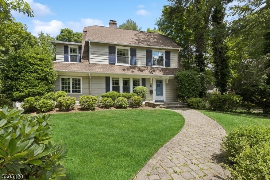 This classic colonial is nestled on a pristine and quiet street in one of Summit's most welcoming and close to downtown neighborhoods. Modern comforts and timeless charm combine to make this property a true Summit gem. Hardwood floors, crown moulding, and a private landscaped .44 acre yard framed by towering oaks, provide an ideal place to call home. Large windows and terrific room flow allow natural light to envelop every corner for a bright and airy feel. The fireplace enhances the classic living room, which leads to a sunny porch adjacent to kitchen dining area.  This area is perfect for gatherings of any size and will be easy to enjoy in this beautiful space which features exposed brick walls. The porch leads out to a large deck with expansive views of the stunning backyard. Updated kitchen with center island and bar area and wine refrigerator are the perfect spot for groups to gather. Five bedrooms and three full baths complete the second and third levels. The en suite primary, complete with frameless, walk-in shower with neutral earth toned stone and tile, make this spacious bedroom an inviting place to relax. The finished basement with half bath provides a great game room, TV, and laundry area.  Located in top rated Lincoln school district.