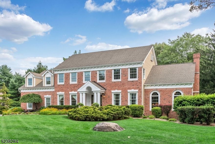 This exquisite luxury home is nestled on a sought-after street, where elegance and sophistication meet nature's beauty. As you approach, a mesmerizing waterfall feature and tranquil pond grace the walkway, setting the tone for the stunning experience that awaits you. This magnificent Center Hall Colonial boasts modern comforts. The attention to detail is unparalleled, with custom woodwork throughout, creating an ambiance of refined luxury. Entertain in style within the Great Room, where 18' ceilings elevate the space, while custom-made corbels add a touch of architectural opulence. As you step outside, a deck with a retractable awning beckons you to the beautifully landscaped backyard oasis. This remarkable property is not only a sanctuary of luxury, but it also offers practicality and convenience. Its commuter-friendly location to NYC ensures you're well-connected while providing a retreat from the bustling city. The outstanding schools further enhance the homes desirability.