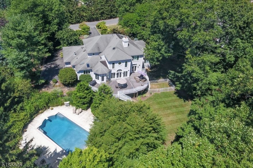 Prestigious Bel Air custom Center Hall Colonial home with approximately 6800 square feet of living space on .8 acres with a spacious backyard and resort-style inground pool provides the ultimate luxury experience. Close to houses of worship, NYC transportation and topnotch schools, this expansive 6+ Bedroom updated custom home boasts exquisite designer finishes everywhere with unparalleled craftsmanship. Circular driveway leads to covered entryway opening to grand 2-story Foyer.  Sunken Family Room features soaring double height ceiling, fireplace, floor-to-ceiling architectural windows. Elegant Living Room and Dining Room. True entertainers' Chef's Eat-In Kitchen with custom high-end counters and appliances, skylights, massive center island, Butler's Pantry + eat-in area with direct deck access and back stairs to 2nd level. 1st Floor Laundry leads to Mudroom and 3-car attached garage. Spectacular 1st Floor Primary retreat with 2 large walk-in closets, sitting area and luxe Bathroom + home Office with fireplace and deck access. Powder Room completes 1st floor. 2nd level features large landing with views of Family Room and Foyer - 3 large Bedrooms + 2 full Baths. Huge Lower Level boasts 2 Bedrooms, a Full Bath, Exercise/Game Room, separate Recreation Room with direct access to the lower patio, pool + 2nd Home Office or 7th Bedroom. Seamless direct access via both the Lower and Main Levels to wrap-around multi level deck overlooking the Resort Style Pool and separate lawn area.