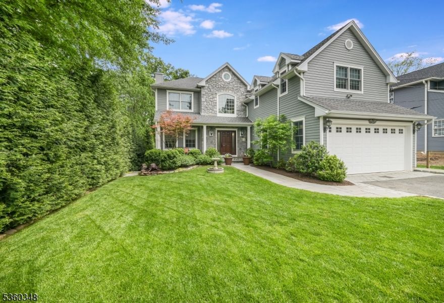 This custom built 3,779 sq ft home will captivate you from the moment you walk up to the Brazilian Mahogany front porch overlooking lush gardens. Enter the 18 ft tall two story foyer & proceed straight to the heart of the home. The open floor plan kitchen/breakfast area/family room (gas fireplace) offers an egress to a spacious Trek deck. The gourmet chef's kitchen is complete w/ large center island, Bosch SS appliances, deep farmhouse sink, exhaust fan, double wall oven, pot filler, pantry & more! Transition from the kitchen to your dining room facilitating large gatherings & life celebrations! The spacious family room offers an abundance of natural light w/ large windows overlooking the backyard. The 1st floor also offers a 5th BR/home office, laundry, powder room, full bath & inside entrance from the finished garage. The 2nd floor offers a picturesque landing overlooking the open foyer, an ideal spot to curl up w/ a book! The 890 sq ft primary suite is bigger than some urban apartments offering tray ceilings w/custom woodwork, two spacious WICs, and a spa feel in the primary bath. Three add'l BRs & a 2nd laundry room accent the 2nd fl. The 1,143 sq ft basement offers a full bath, 9 ft ceilings, 3 large egress windows & awaits your imagination on how you will utilize this space. Large WIC for future wine cellar, stairs to garage! Outside relax on your 370 sq ft deck overlooking spacious yard. 0.4m to AWR Elementary, 0.6m to award winning MS/HS. Easy access to bus/train.