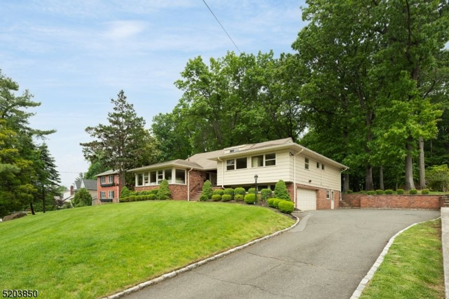Talk about location. This mid century modern rests on nearly a half an acre in the most desirable Hartshorn section of Short Hills. It is in close proximity to highways, trains, shopping, downtown Millburn and only .2 miles to the Hartshorn Elementary School. This 5 bedroom, 4.1 bath custom home has a bright and open floor plan. Once entering the home you are welcomed by large rooms and expansive views to outside through the oversized windows. The first floor has a large living room that opens to a dining room. In the back of the home is the eat in kitchen and large family room that both look out onto the beautifully flat and private backyard. The second floor has the master suite with nice closets and an en suite bath. The second floor is completed by two additional bedrooms and a bathroom. On the floor above, you will find 2 additional bedrooms, one bathroom and a storage closet. On the level just below the main living area is a large family room or rec room with a full bath. This floor also has the 2 car garage. The basement is large and unfinished. Once you step outside to the patio and yard you are sure to fall in love with this beatiful home.