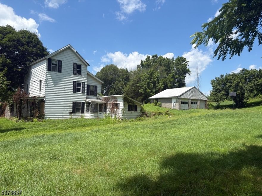 The value is in the land. The lot is 0.83 acres and is fully cleared. Bring your imagination, zoned R4 with a variance, endless possibilities. There is no information available about the well or septic system. Comes with engineering plans for a new septic and plans for a new house; the costs were approximately $10k for the drawings and plans, which were all approved by Vernon Township. The house is not habitable.