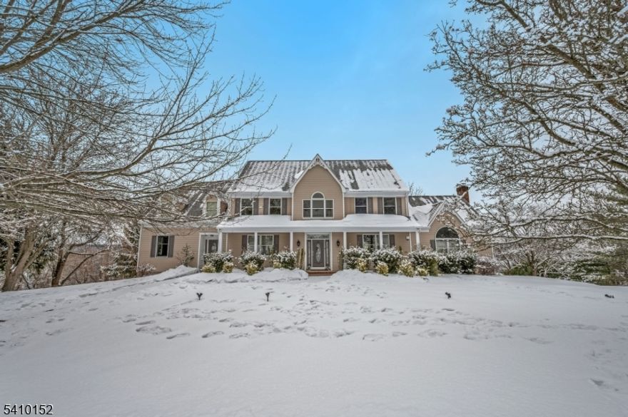 Nestled at the end of a private drive, 10 Red Robin Way is a masterclass in colonial elegance and modern versatility. Set on a sprawling 2.778-acre estate, this 4,500-square-foot residence offers a rare combination of sanctuary-like privacy and expansive living space, tailored for those who demand both luxury and functionality. The heart of the home is the gourmet kitchen, featuring a center island and a walk-in pantry, flowing effortlessly into a casual dining area with serene views. The adjacent great room is anchored by a dramatic floor-to-ceiling stone fireplace and soaring beamed ceilings bathed in natural light.  With 5 bedrooms and 5.5 baths, the home provides ample room for entertaining. The meticulously finished walk-out basement serves as an entertainment hub, perfect for a home gym or game room. Outside, enjoy absolute tranquility and skyline views from your private forest. Located in a top-rated school district near downtown Flemington, this estate offers the very best of Hunterdon County living.