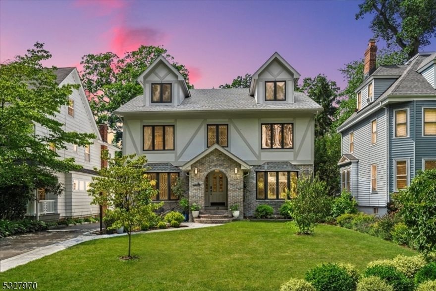 Welcome to this stunning 3,600 sq. ft. Colonial, perfectly situated on one of Glen Ridge's most desirable streets. From the moment you enter, this home impresses with its timeless charm, modern upgrades, and exceptional living space.The gracious entryway leads to sunlit living and dining rooms adorned with elegant leaded glass bay windows and brand-new floors. A spacious home office and an inviting family room with wainscoting, a stately fireplace, and sliding doors to the backyard create a perfect blend of functionality and comfort for entertaining or daily living. The heart of the home is a beautifully designed kitchen with crisp white cabinetry, quartz countertops, double ovens, a gas cooktop on the center island, and a breakfast nook with serene views of the private backyard. Completing the first floor are a convenient powder room and a laundry area. Upstairs, five spacious bedrooms with ample closets and gleaming new floors await. The luxurious primary suite boasts two walk-in closets, a spa-like bathroom with a soaking tub, stall shower, and double vanity, plus a private balcony overlooking the backyard. A chic hall bath completes this level. The Finished Basement is a standout feature with 9-foot ceilings, a full bathroom, and a private sauna perfect for unwinding. This space offers a second family room, office, workout area.   2023 Upgrades include New  Central Air , Security System,  Interior Paint,  New Floors on 1st Floor, Whole-House Generator.  Home Sweet Home