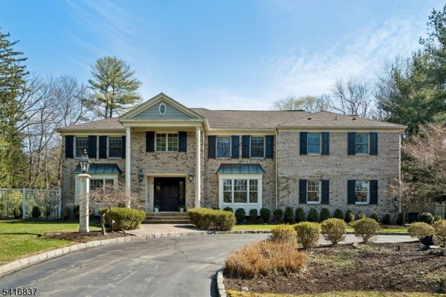 This elegant 6 bedroom Brick Front Colonial is ideally located on .49 acres on quiet cut de sac in highly rated Hartshorn Elementary District. It is south facing so kitchen, family room & totally level backyard get great natural light! It has been thoughtfully rebuilt, remodeled & designed by highly regarded architects David Rosen & Timothy Klesse. This stunning home features circular driveway, grand entrance hall, a gourmet chef's kitchen with top of the line appliances, Subzero refrigerator/freezer & 6 burner Wolf range w/griddle & pot filler,  Miele DW totally open to family room w/gas fireplace & French doors open to expansive patio & beautiful totally level, fenced backyard, large & bright living and dining rooms, perfect for entertaining, 1st level guest bedroom w/full bath, & easy 1st level access to attached 2-car garage. The 2nd level has a huge luxurious Primary Bedroom w/walk-in custom closet, & beautiful spa-like primary bath w/skylight, double vanities, bathtub under a wall of windows w/views of the private backyard & a huge marble shower. There are 4 more spacious bedrooms, including a 2nd Primary Suite, & 3 more full baths + laundry rm. There is a 3rd level loft, & beautifully finished lower level w/Media/Rec room w/bar/kitchenette, powder room & exercise room. Custom millwork & extensive moldings. 2 car garage w/ EV charger. The patio, koi pond & grounds were designed by a landscape architect who values beauty & privacy in the great outdoors. Your dream home!