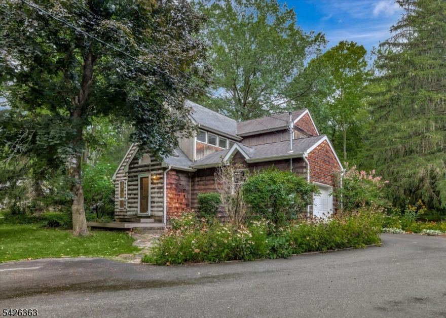 Set on a quiet, sunny acre at the edge of Hopewell Boro, this light-filled, thoughtfully remodeled home combines a rare blend of privacy and open space with expansive nature views. All within close proximity to local dining, shopping, and commuting routes. Airy and open with plenty of room for entertaining, the main level features generously sized dining, living, and family rooms that flow easily into a central kitchen. A dedicated home office, offering flexible use as a workspace or multipurpose room, overlooks acres of undeveloped woods. Upstairs, a bright central landing leads to a primary bedroom with a walk-in closet, a recently renovated (2019) bath and two additional spacious bedrooms, all with large custom windows. New carpeting was installed throughout the upper-level bedrooms (2025) and all bedrooms were repainted (2026). Outside, enjoy morning coffee or summer dinners and relax on the large, private rear deck surrounded by mature gardens and ample green space. An attached garage & full basement provide additional flexibility and storage. Recent improvements include new kitchen flooring and refrigerator (2025), as well as a new washer & dryer (2024). Additional updates include a water softener (2017) and an upgraded drainage system with an outdoor French drain (2013). Ideally located in Hopewell Township in the Hopewell Valley Regional School District, just minutes from Princeton & Lambertville, with convenient access to major highways, rail lines, and Philadelphia.