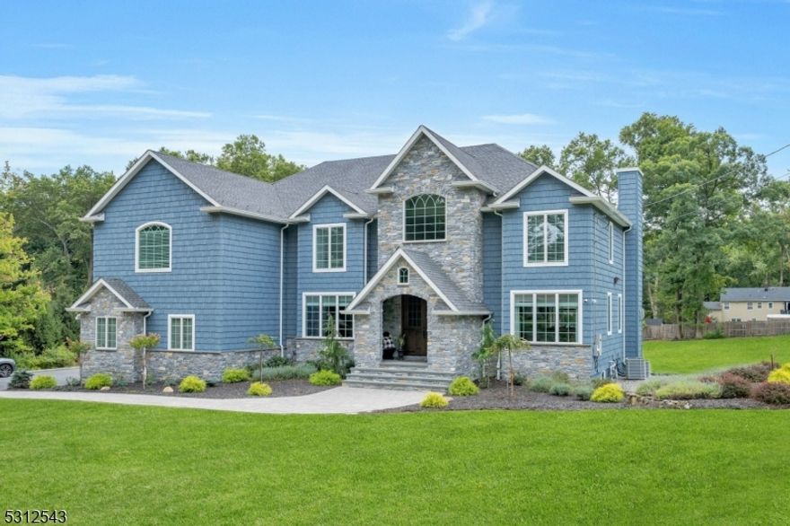 Welcome home to this one of a kind custom built home located in one of the most desirable sections of Parsippany. Perfectly situated on a pristine landscaped 1.7 acre lot with a separate detached guest house and a 45x30 paver patio for year round gatherings. The outstanding construction features incl: closed cell foam insulation along with a High Efficiency HVAC system which drastically reduces utility bills, the entire house in covered with real natural stone & Certainteed Vinyl Cedar Impression Siding as well as shaker corners, all interior walls have been insulated with sound proofing, 16 camera security system, lrg outdoor kit & bar, Anderson 400 series casement windows throughout, oversized base, casement & crown molding, 3 electrical panels, in wall HDMI & Cat 6 ethernet wifi extenders, 10 ft high bsmnt ceiling, all copper plumbing, high end kitchen cabinets with double waterfall edge, SS appliances, 2 tier center island, dark walnut oak stairs with wrought iron spindles in foyer & bsmnt, central vacuum, ceiling speakers thru out, 7 lights @ 24k lumens stadium spotlights, 130+ recessed lights, decorative shiplap ceilings (interior & exterior), and a sort after property that is not often available!! Approx 4800 sq ft of living space and an add'l 1800 sq ft in the bsmnt. Finished Basement with Full Bathroom & Bar, Minutes to major highways, schools, shopping & public transportation. Truly a dream come true! This impressive home is awaiting the most discerning of buyers!!