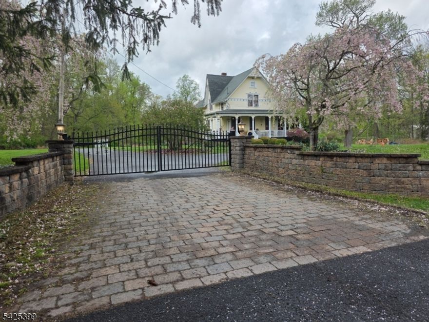 Circa 1860 Timeless Victorian w/Modern Comforts & Exceptional Outdoor Living! Rare opportunity to own an authentic 19th-century Victorian where preserved craftsmanship meets thoughtful updates Wraparound covered porch w/mahogany flooring (needs to be brought out) sets the tone, leading into a light-filled interior w/12' high ceilings (10' high in basement w/cement floors) & original wide plank pumpkin pine floors Updated kitchen features granite countertops, stainless steel appliances, flows seamlessly into a mudroom w/direct access to a private patio & 10 person hot tub ideal for everyday living & entertaining. A radiant-heated bath adds comfort, while a pellet stove provides efficient supplemental heat. Outdoors, the property truly stands out Lush, seasonally curated landscaping surrounds a large paver patio & Large Historic Red Barn/workshop w/4 bays, perfect for hobbyists, storage, or creative use Border Hoffman Park w/horse bike jogging trails Major improvements include roof & septic (2015), circular driveway w/Wrought Iron Gate. Original architectural details remain intact showcasing the home's circa 1860 character Expansion plans for 2nd bath & 1st flr bedroom offer future potential.Ideally located minutes to Route 78, NYC transit, river towns, & Spruce Run Recreation Area This property offers a rare balance of privacy, accessibility, & lifestyle.A distinctive home for the buyer who values history, land, & lasting quality! A property with presence..This is the one!