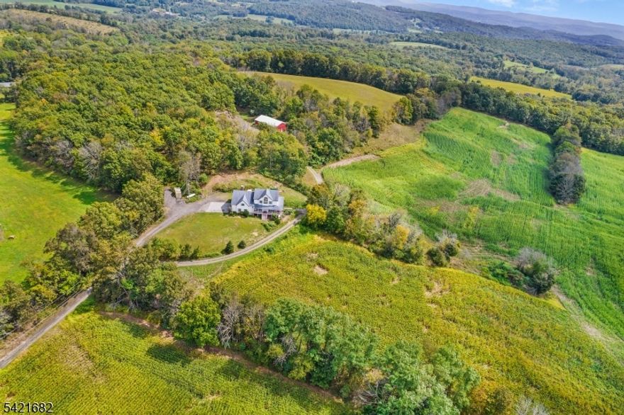 Where Land, Lifestyle, and Legacy Come Together.This one-of-a-kind farmhouse, thoughtfully built and meticulously cared for by its original owners, offers 5 bedrooms, 3 full bathrooms, and a finished basement, all set on 23 acres of fully usable land perfect for farming, livestock, crops, or simply enjoying wide-open space and privacy. Inside, the home delivers both space and flexibility, with a layout designed for comfortable everyday living and long-term versatility. The finished basement adds valuable additional living space ideal for recreation, guests, or extended use. Step outside to a sprawling rear deck, perfect for entertaining, and a classic wraparound porch the kind of place where mornings start with coffee and quiet views, and evenings end with fresh air and sunsets. For those seeking functionality beyond the home, the property features a massive pole barn in excellent condition, ideal for equipment, storage, or hobby use. Additionally, a large unfinished bonus area with utilities already in place provides the opportunity to create the exact space you've always envisioned.Properties like this are increasingly rare offering acreage, usability, and a home built with care and intention. This is more than a home  it's a lifestyle, and a truly special piece of land.