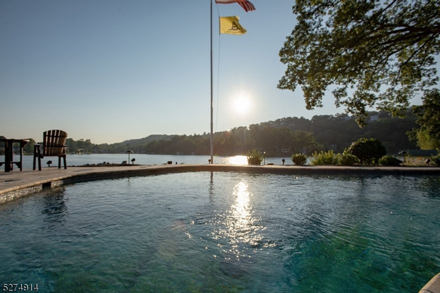 Welcome to the epitome of luxury living on the shores of Lake Mohawk. This extraordinary lakefront home is located on Manitou Island, and offers the perfect blend of old Crane charm, privacy and opulence. Ideally suited for entertaining, the recent renovation of this 5-bed, 6-bath home makes it truly the jewel of the lake.As you cross the bridge and approach the property, a picturesque landscape greets you, and an immediate sense of seclusion and privacy. Situated on over one acre, the property commands a prime location, with panoramic views of the shimmering waters of Lake Mohawk stretching out before you.Stepping inside, you are immediately struck by the grandeur and elegance of the home's design. Expansive windows frame breathtaking vistas of the lake, allowing natural light to flood the interior and create an inviting ambiance. Vaulted ceilings and open-concept living spaces enhance the sense of spaciousness, while fine architectural details and premium finishes lend an air of sophistication throughout.The luxury kitchen is a chef's dream, featuring top-of-the-line appliances. Adjacent is a formal dining room, ideal for hosting intimate gatherings or lavish dinner parties, with French doors leading out to a sprawling deck overlooking the water. Lake Mohawk is New Jersey's largest private lake, and only about 50 miles from NYC. Don't miss the opportunity to make this exquisite residence your own and enjoy the very best of what lake life can offer.