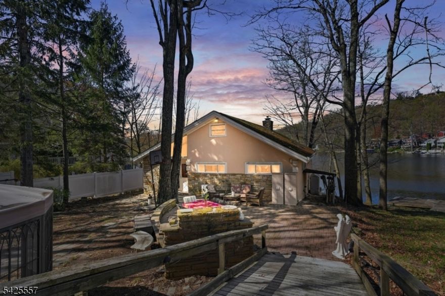 Spacious 4-bedroom, 3-bath waterfront home located on Crescent Cove, set on a rare private double lot. This property features an open floor plan with high ceilings and abundant natural light throughout. The lower level offers excellent in-law suite potential with a separate walk-out just add a kitchen to complete the space. Enjoy direct lake access with a private dock and jet ski lift, perfect for boating and water recreation. Tons of land with an additional vacant lot next door offers the potential to build a garage or boathouse. Ideal for year-round living or as an investment property with strong Airbnb potential. This home is priced to sell, if refinished home value estimated around $1M.