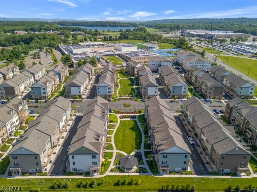 Stunning 3-level townhome, approx. 2000 sq ft of modern living in the sought-after Livingston Square community. Built in 2021, this home features a flexible floor plan with numerous upgrades, ideal for today's changing lifestyles, and a low monthly maintenance fee. The main level showcases an open-concept living, dining, and kitchen area bathed in natural light via oversize windows, upgraded wood floors, a built-in office nook, and a private deck. The gourmet center island kitchen boasts quartz countertops, stainless steel appliances, and a large double pantry. Upstairs are three spacious bedrooms and two full baths, including a luxurious primary suite with two walk-in closets and a tray ceiling. The laundry is conveniently located on the bedroom level. The ground level includes a sunlit office/den (potential 4th bedroom) and access to a 2-car garage with epoxy floors and Tesla charger. Other features include ceiling fans in every room, water softener, reverse osmosis filter, and Container Store closet systems in the 2nd, 3rd bedrooms. The home overlooks a beautifully landscaped green space (largest in the community) with a gazebo. Conveniently located close to train and bus with service to NYC, and within walking distance to Livingston Mall and the express shuttle to S. Orange train station. Close to world-class shopping at The Mall at Short Hills, dining, parks/recreation, and top-rated schools. Great opportunity for investors or quick move-in!