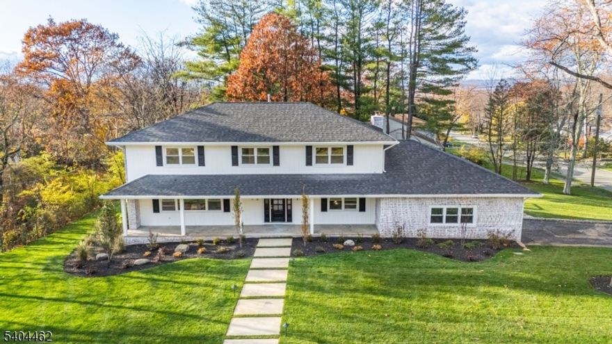 Sophisticated modern living in this renovated down-to-the-studs rebuild offering 4 bedrooms with a flexible 5th bedroom/office option and 4.5 designer baths. Set in one of West Caldwell's most desirable neighborhoods, this home blends elevated craftsmanship with a warm contemporary aesthetic just 19 miles from NYC. The main level features sun-drenched open-concept living, white oak flooring, designer lighting, and a custom plaster fireplace. The chef's kitchen showcases Taj Mahal quartzite, GE Monogram appliances, natural wood cabinetry, a walk-in pantry, custom plaster hood, and a built-in breakfast nook. A striking arched bar enhances the dining room for effortless entertaining. The luxurious primary suite offers a tray ceiling, walk-in closet, and a bath with Italian marble and a floating double vanity. Secondary bedrooms provide generous space, great light, and beautifully finished baths. The finished walk-out lower level adds a custom wet bar, full bath, and direct access to the covered patio, ideal for a gym, media room, or guest suite. Every major component is new, including plumbing, electric, roof, windows, siding, and 2-zone HVAC. Outdoor living features a MoistureShield deck, bluestone porch, new driveway with Belgium block, East Coast-installed sod, Rain Bird irrigation, and low-voltage lighting. A TRUE TURNKEY LUXURY home close to top-rated schools, downtown, shops, and restaurants.