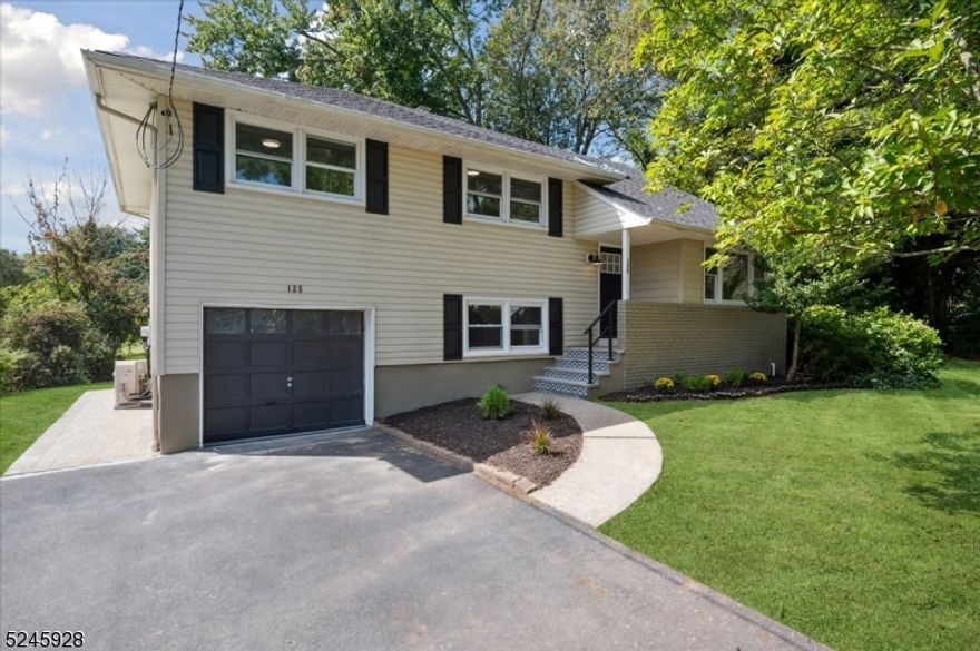 Beautiful & COMPLETELY RENOVATED Split Level Home just waiting for you to move in and enjoy! With 4 bedrooms + 2 1/2 bathrooms and designer details throughout, all set on a corner lot with convenient access to schools, shopping, dining, parks and major highways. Just minutes from 3 Direct Train Stations to New York City . Past an inviting front porch and foyer, the main level opens with gleaming hardwood floors and recessed lighting in the spacious living and dining rooms. Just beyond the beautiful kitchen with classic white cabinets, SS appliances, gorgeous quartz counters, subway tile backsplash and peninsula with extra seating. Wood floors continue upstairs to 3 bedrooms, all serviced by a full hall bath with storage vanity and a tub/shower combo with marble tile and oil-rubbed bronze fixtures. A huge, tranquil primary suite on the top-level features plush carpet, recessed lighting, skylight, 3 closets, sitting area, and an adjoining beautiful en-suite bath with shower. The ground level offers a family room with access to the attached 1-car garage and a big laundry room with outside entry and adjoining half bath, while a pristine basement level houses the utilities. A new paver patio accessible from the dining room & lower level leads out to a sprawling backyard surrounded by mature plantings for privacy, providing ample space for cookouts, relaxing & entertaining. Brand NEW Roof, Doors, Furnace, AC, Water Heater & more. Nothing to do here but unpack!