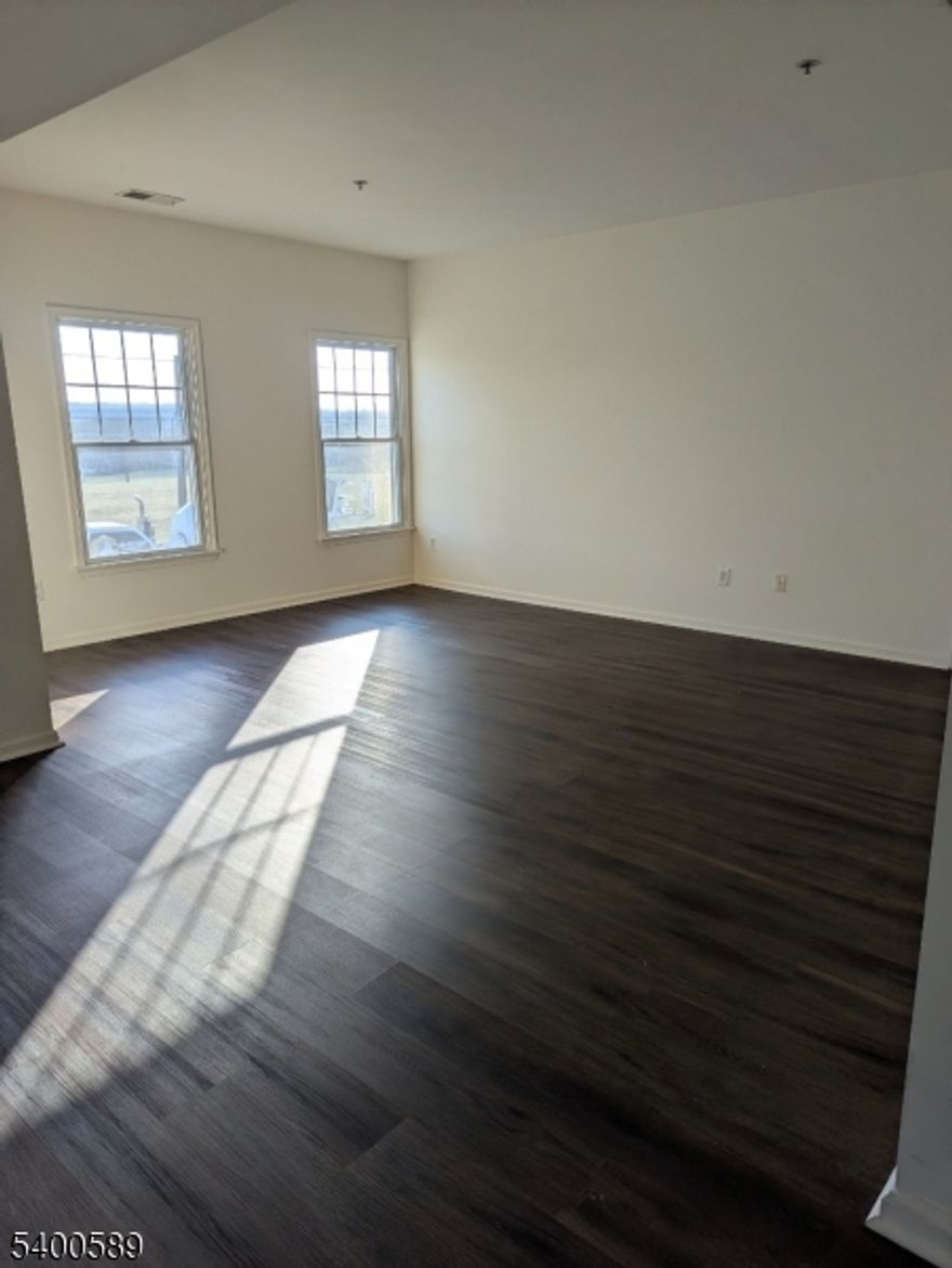 Bright and sunny. Wood floors. open spaces view of Golf course pond across the street. Steps to second floor unit