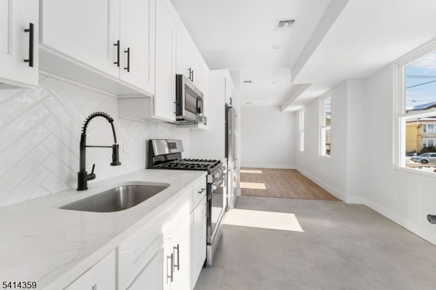 Newly built 3-family property offering a 5 Year Abatement!!! This is a turnkey investment opportunity in a prime commuter location near NYC bus lines and train station. Designed with modern living and long-term durability in mind, this multi-family delivers quality craftsmanship and brand-new finishes throughout. The property features a total of 9 bedrooms and 5 full bathrooms across three thoughtfully designed units with 9-foot ceilings that enhance natural light and create an open, contemporary feel. Each unit includes modern kitchens and bathrooms with new cabinetry and fixtures, as well as dedicated in-unit laundry for added convenience. Built for comfort and performance, the property includes newly installed HVAC, electrical, plumbing, and mechanical systems. Double insulation and soundproofing between units provide enhanced privacy and energy efficiency. A finished basement with a full bathroom adds additional flexibility and functional space. Two garages with parking capacity for up to six vehicles offer a rare and valuable amenity for both tenants and owners. Ideal for an owner-occupant seeking to offset expenses with rental income or an investor looking to add a low-maintenance, income-producing asset in a strong commuter market.