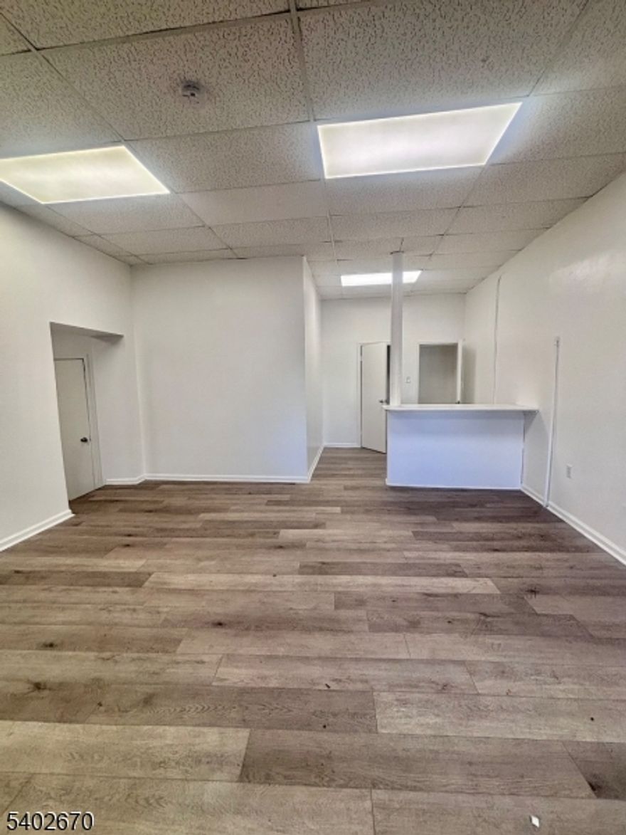 Unlock the potential of your business at 404 Hawthorne Avenue, a premier commercial destination in the heart of a vibrant Newark neighborhood. Offering 1,400 square feet of versatile, open-concept space, this property is perfectly suited for entrepreneurs, retailers, or professional service providers looking to plant roots in a high-growth area. This storefront boasts significant street-level frontage on a bustling corridor, ensuring your brand stays top-of-mind for the steady stream of daily commuters and local residents. The interior features large display windows that flood the space with natural light, creating an inviting environment for clients and a bright, productive workspace for your team. The flexible layout allows for effortless customization, whether you envision a modern retail boutique, a professional office suite (legal, insurance, or accounting), a wellness studio, or a creative agency.Strategically positioned just minutes from I-78, the Garden State Parkway, and Route 22, your business will be easily accessible to clients from across Northern New Jersey. For those relying on public transit, proximity to local bus routes and Newark Penn Station ensures a seamless commute for both employees and visitors.