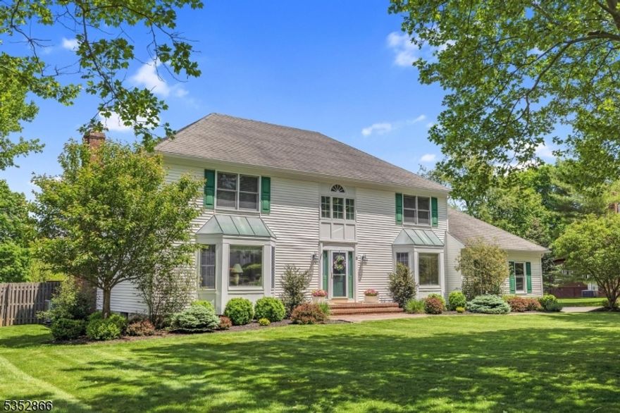 Spacious 5 bedroom colonial with 1st floor bedroom or office, huge level and usable yard with fulll fencing, public utilities and more!  Large eat-in kitchen with granite counter tops, family room with gas fireplace surrounded by custom built-ins and sliding glass doors to large composite deck, formal living and dining rooms with hardwood floors and bay windows, spacious foyer and powder room round out the first floor.  Second floor features primary suite with large walk-in closet and full bath with stall shower, as well as 3 additional huge bedrooms and main bath with double vanity and tubshower.  All hardwood upstairs and downstairs, including under carpeting in living room and dining room. Pull down attic stairs for storage.  Basement is fully finished with rec room featuring dry bar for entertaining, exercise room and has additional storage closets.  Public water and sewer, Cucinella elementary school and West Morris Central High School with IB program!  Minutes to Rts. 46 and 80.