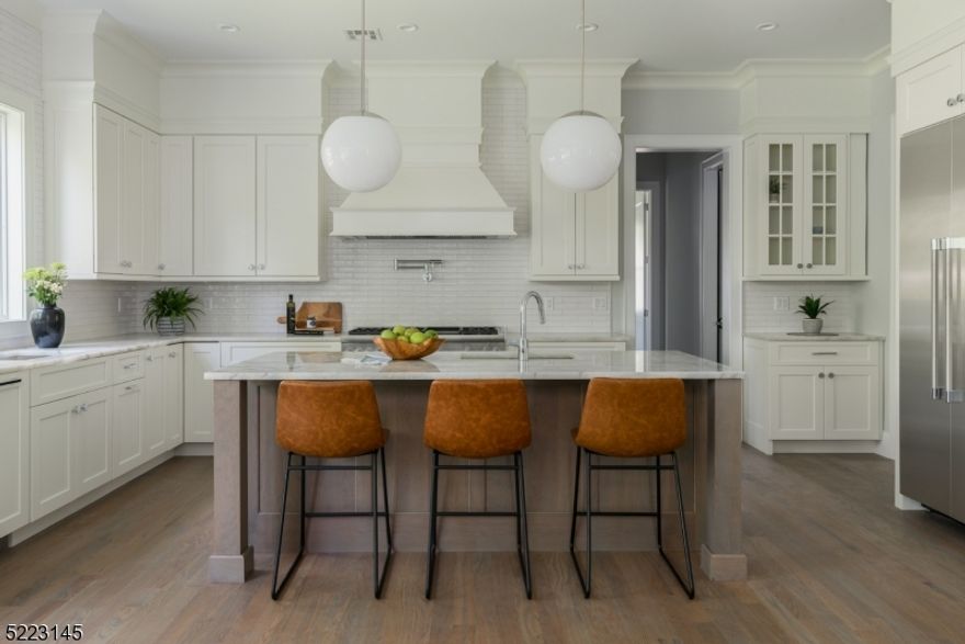 Embrace unparalleled luxury in this extraordinary NEW CONSTRUCTION appointed in the prestigious Rolling Hills section of Summit. A picturesque covered front entry greets you w/ a grand foyer. To the right, a formal dining rm awaits setting the stage for unforgettable gatherings. Equipped w/ a bar & a walk-in pantry, this space seamlessly connects to the custom kitchen. A chef's dream, featuring top-of-the-line Thermador appliances, center island w/ seating/prep sink, & 8-burner gas range that inspires culinary excellence. An eat-in area provides casual dining, opening up to a deck that extends the living space outdoors. The kitchen flows seamlessly with the family rm, creating a harmonious & inviting atmosphere that encourages effortless conversation & relaxation w/ an adjoined formal living rm. Completing the main level, is a powder room, a first-floor en-suite bedroom/office, & interior garage entrance w/ mudroom for functional living. 2nd floor boasts an opulent primary suite, a spa-like primary bathroom featuring the stall shower, indulgent soaking tub, a dual vanity, & an enormous shared walk-in closet w/ a bonus room. All generously sized bedrms, two are Jack & Jill, and the 4th bedrm is en-suite. The second floor is complete with oversized laundry room. The basement level boasts a generous recreation rm, leisure rm, movie rm, and bedrm w/ full bath. Secluded & private backyard, surrounded by lush greenery & offering ample space for outdoor enjoyment. AND MORE!