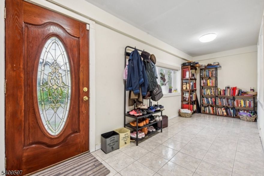 This spacious and move-in beautiful home has it all, updated through-out the entire home.The first level as you enter is a grand enclosed porch with a large picture window that is perfect for an home office. Enter through French Door into a large living room with a fireplace, a formal dining room, and the beautiful kitchen ready for the best chef and completing the first level with an powder room. The kitchen French Doors lead you onto a grand covered patio and fenced in backyard for entertaining. The second level has 3 bedrooms, one made as a walk in closet and a beautiful updated full bath.The third floor bedroom is perfect and spacious. The full finished basement is ready for recreation and offers a lovely full bath. This entire home is move-in ready and the location is walkable to supermarkets, restaurants, transportation to NYC and more.