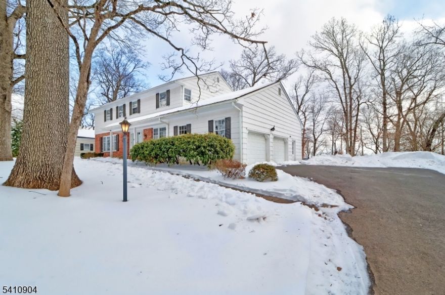 Situated on a large lot with a level yard and views of the NYC skyline, this home is well-lit with ample natural light throughout. This stately colonial has a well-proportioned floor plan and functional flow with its generous entry foyer, which leads to both formal and informal spaces. The living room and dining room provide elegant entertaining spaces, while the family room features a cozy fireplace. Hardwood floors run throughout most of the home, providing a rich warmth. The eat-in kitchen is equipped with a pantry closet, a separate eating area, overlooking the yard and a well thought out space for your culinary instincts. A first-floor laundry room, powder room, two rear doors to yard and two-car attached garage add to the well thought out floor plan. The finished lower level offers plenty of recreation space and additional storage. This home is located in the coveted Highlands community. Chatham schools are consistently ranked among the finest in NJ. Located approx 30 min from Newark Int'l Airport and a short drive to Chatham train station offering NYC mid-town direct service