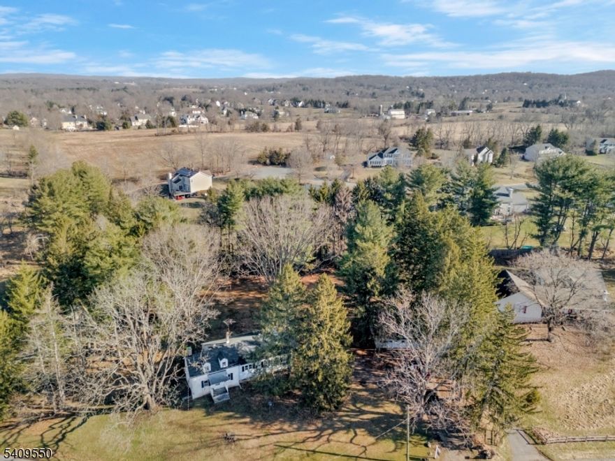 Bring your vision and restore the charm of this 1840 renovation opportunity set on a full acre along a desirable, upscale road. This one-level home offers four bedrooms and one full bath, providing a flexible layout ready for transformation. The spacious eat-in kitchen flows into a comfortable living room highlighted by a wood-burning fireplace, creating a warm focal point for the home. Original character and timeless potential await your updates and personal touches. A detached garage provides added convenience with extra storage or workshop possibilities. Nestled on a generous lot with room to expand, garden, or reimagine the outdoor space, this property presents a rare opportunity to create your dream home in a sought-after location. Bring your ideas and make this historic gem your own! Rich in history and surrounded by higher-end properties, this home is ideal for investors, renovators, or buyers looking to restore and customize a property with timeless appeal. Conveniently located yet privately set, this is a rare chance to create something special in a sought-after setting.