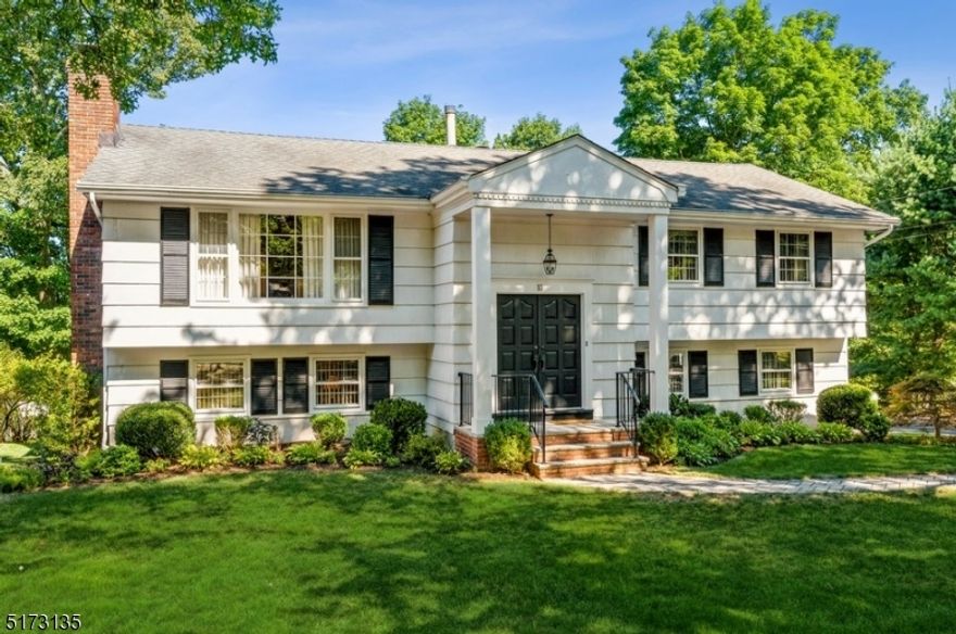 Spacious & stylish in northern Bergen County! Beautifully maintained Bi-Level home with four bedrooms, two full bathrooms, and one half bathroom is situated on a manicured lot in Oakland. This spacious home is just half a mile to schools and mere minutes to shops, eateries, parks, lakes, and Routes 287 and 208. Move right into this impeccable home featuring warm hardwood floors, crown molding, trim detail in the dining room, an attached two-car garage, and a beautiful deck overlooking a private yard with a patio and trees screening off your neighbors.  The welcoming foyer opens to a light-filled living room with a big picture window and an open dining area with views of the backyard. The bright, eat-in kitchen has chic white cabinets, granite counters, tile backsplash, stainless steel appliances, and glass sliders to the deck that is ideal for entertaining. Down the hall, the primary bedroom includes a walk-in closet and a private en-suite full bathroom. There are two additional bedrooms and a full hallway bathroom with a dual-sink vanity. On the ground level is a warm and comfy family room with a wood-burning fireplace surrounded by an exposed brick wall. This level includes a fourth bedroom that could be used as a home office, a half bathroom, laundry room, access to the attached garage, and a walkout to the patio. This home is move-in ready, conveniently located, and waiting to be enjoyed!