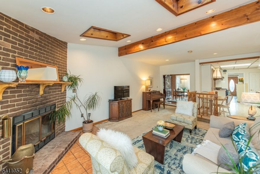 The freshly painted darling colonial intrigues w/ endless potential & versatile floorplan! 1st flr features cozy sunroom, elegant living room, spacious dining room open to kitchen (w/ plenty of cabinetry & counter space for holiday hosting), as well as a surprisingly large rec room w/ vaulted ceilings, fireplace, skylights & new sliders w/ built in blinds to the patio & adorable back garden. 2nd flr boasts bright primary, 2 sweet bedrooms (1 captive) & sizable full bath. Thru the primary, stairs lead to 3rd flr finished room ideal for office or den. Finished basement highlights full bath & rumpus room perfect for play space or TV room. Shared driveway + street parking, newer hot water heater, solar panels (owned), updated electric, new windows & storage galore, this charming home is mere moments to schools, GSP, shops, Brookdale Park, eateries, all that neighboring Montclair has to offer & easy access to NYC transportation, making it a commuter's dream. Delightful at every turn!